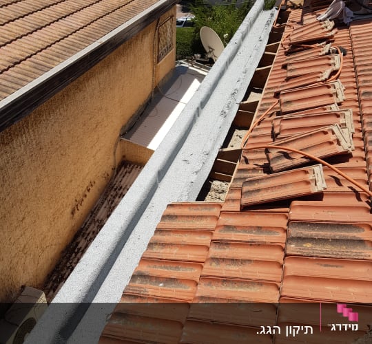 רעפים כתומים על גג עם תיקונים וחוטים